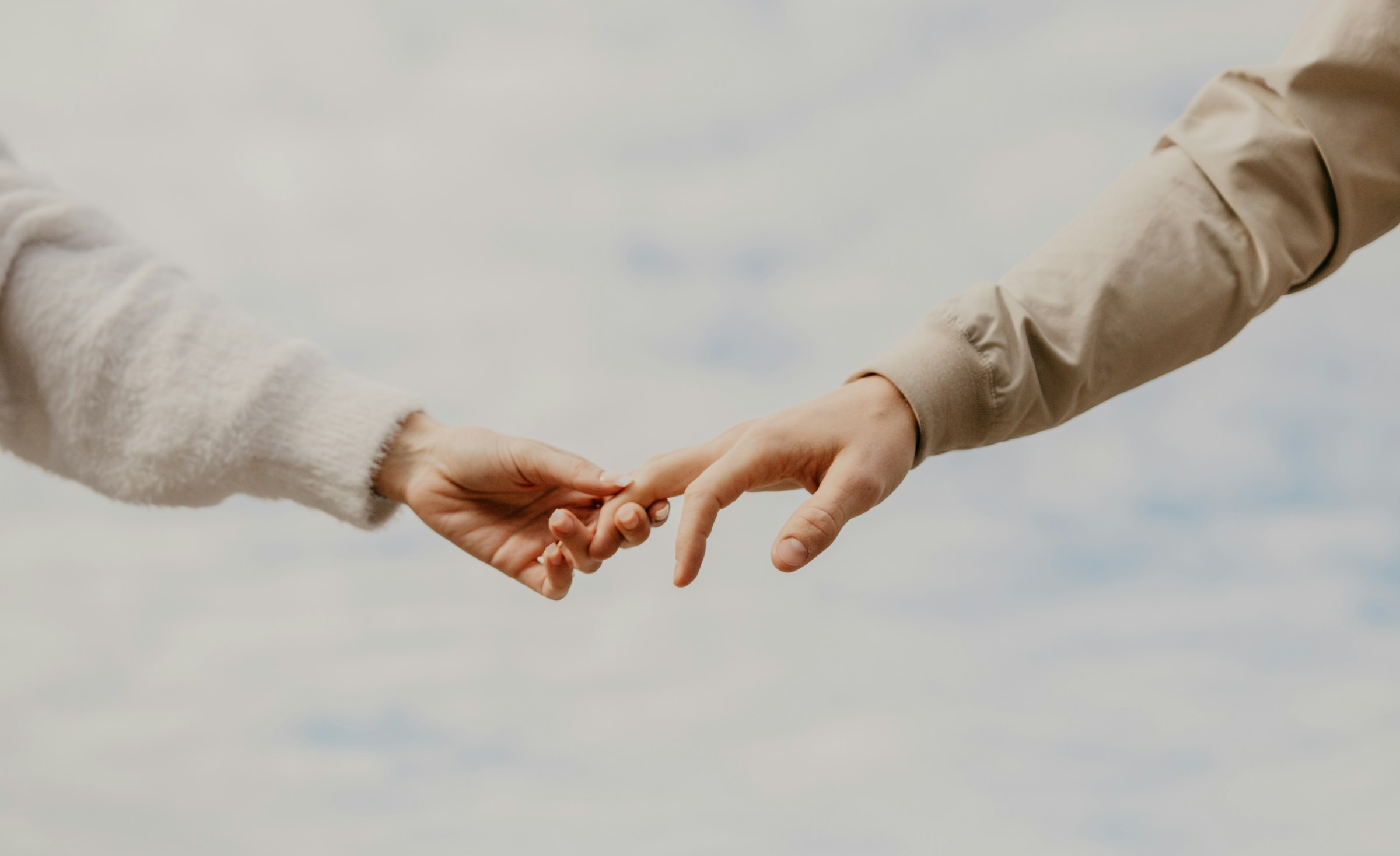 Two hands reaching for each other